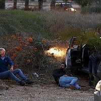 Israelis take cover as rockets are fired from the Gaza Strip, in the southern Israeli town of Sderot on November 12, 2018 (Jack GUEZ / AFP)