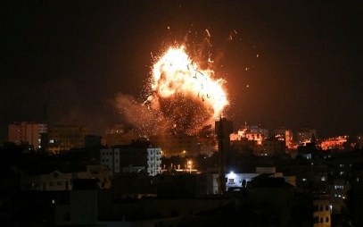 A picture taken on November 12, 2018 shows a ball of fire above the building housing the Hamas-run television station al-Aqsa TV in Gaza City during an Israeli air strike. ( Bashar TALEB / AFP)