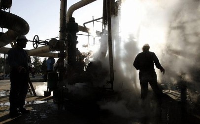 In this Nov. 17, 2007 file photo, a worker repairs a part of a unit of the Tehran oil refinery, in Tehran, Iran. (AP Photo/Vahid Salemi, File)