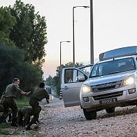 Israeli soldiers lying on the side of the road in southern Israel as they take cover from incoming rockets fired from Gaza into Israel, November 12, 2018. Hadas Parush/Flash90