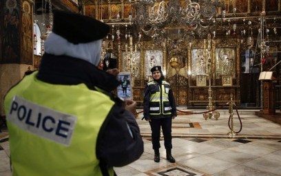 Palestinian female police officers take pictures inside the Church of the Nativity in the biblical West Bank city of Bethlehem, on December 24, 2018. (HAZEM BADER/AFP)