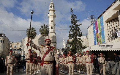 A Palestinian band performs on Manger square in front of the Church of the Nativity in the biblical West Bank city of Bethlehem, on December 24, 2018. (HAZEM BADER/AFP)