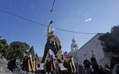 Palestinian bagpipers perform on Manger square in front of the Church of the Nativity in the biblical West Bank city of Bethlehem, on December 24, 2018. (Musa Al SHAER/AFP)