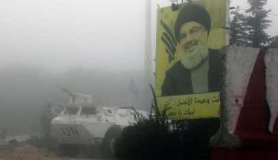 A United Nations Interim Forces in Lebanon (UNIFIL) vehicle patrolling in southern Lebanon on the border with Israel is parked next to a poster showing Hassan Nasrallah, on December 9, 2018. 
