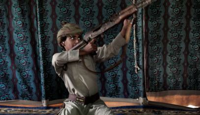 Kahlan, a 12-year-old former child soldier, demonstrates how to use a weapon, at a camp for displaced persons where he took shelter with his family, in Marib, Yemen, July 27, 2018.
