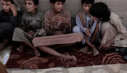 14 year-old Abdel Hamid, second right, and 14 year-old Morsal, third right, sit at a camp for displaced persons where they took shelter, in Marib, Yemen, July 27, 2018.