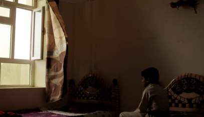 A boy sits on his bed in a rehabilitation center for former child soldiers in Marib, Yemen, July 28, 2018.