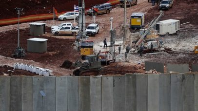 Israeli military equipment works on the Lebanese-Israeli border next to a wall Israel built  (Photo: AP)