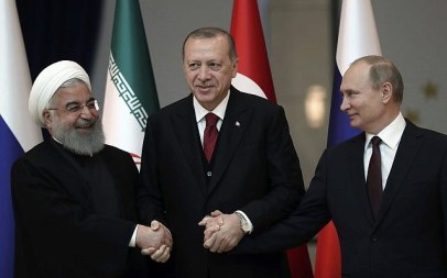 Iran's President Hassan Rouhani, left, Russia's President Vladimir Putin, right, and Turkey's President Recep Tayyip Erdogan lock hands during a group photo in Ankara, Turkey, April 4, 2018. (Tolga Bozoglu/Pool Photo via AP)