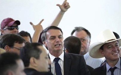Brazil's president-elect Jair Bolsonaro, center, poses for photos during a lunch with popular singers who supported his campaign, at the Army Club, in Brasilia, Brazil, Tuesday, Dec. 11, 2018. (AP/Eraldo Peres)