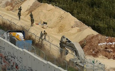 In this photo released by Hezbollah Central Military Media, Israeli military diggers work on the Lebanese-Israeli border next to a wall that was built by Israel facing the southern village of Kafr Kila, Lebanon on Dec. 4, 2018. (Hezbollah Military Media via AP)