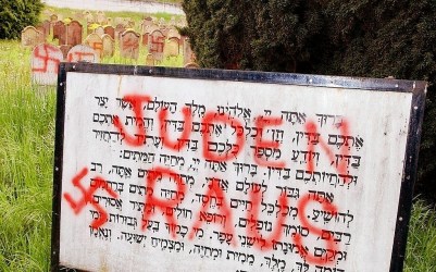 Illustrative: Nazi signs reading 'Jews out' and swastikas are painted at the entrance of a Jewish cemetery in Herrlisheim, eastern France, in this April 30, 2004 photo. (AP Photo/Gil Michel)