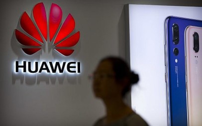 A shopper walks past a Huawei store at a shopping mall in Beijing Wednesday, July 4, 2018. (AP Photo/Mark Schiefelbein) A shopper walks past a Huawei store at a shopping mall in Beijing Wednesday, July 4, 2018. (AP Photo/Mark Schiefelbein)