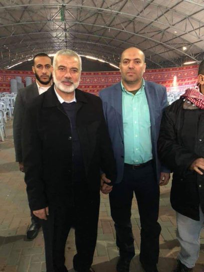 Jasser Barghouti holds hands with Hamas political leader Ismail Haniyeh in an image taken after the Ofra attack