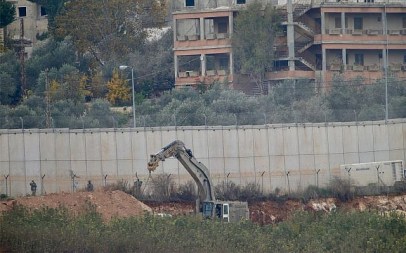 An Israeli military digger works on the border with Lebanon in the northern Israeli town of Metulla, December 4, 2018. (AP Photo/Ariel Schalit)