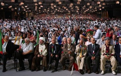 People hold pictures of relatives killed by the Iranian regime during the 'Free Iran 2018 - the Alternative' event on June 30, 2018, in Villepinte, north of Paris. Six people were arrested in Belgium, Germany and France for an alleged plot to attack the rally, including an Iranian diplomat and his wife. (AFP Photo/Zakaria Abdelkafi)