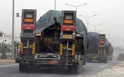 A Turkish convoy of trucks carrying tanks destined for Syria is pictured near the town of Reyhanli, Turkey, September 13, 2018. (Ersin Ercan/DHA via AP)