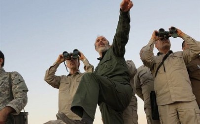 The government-controlled Syrian Central Military Media shows Iran's army chief of staff Maj. Gen. Mohammad Bagheri, left, looks into binoculars as he visits and other senior officers from the Iranian military on a front line in the northern province of Aleppo, Syria, October 20, 2017. (Syrian Central Military Media, via AP)