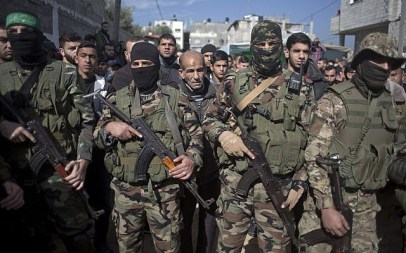 Masked gunmen take part in the funeral of Mahmoud al-Nabahin, a member of the Hamas terror group's military wing, in Buriej refugee camp, central Gaza Strip, on January 23, 2019. (AP Photo/ Khalil Hamra)