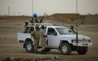 In this July 28, 2013 photo, United Nations peacekeepers stand guard at a polling station, during presidential elections in Kidal, Mali. (AP/Rebecca Blackwell)