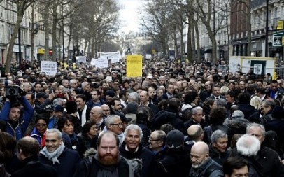 Participants walk behind banners holding placards during a silent march in Paris in memory of Mireille Knoll, an 85-year-old Jewish woman murdered in her home in what police believe was an anti-Semitic attack, held on on March 28, 2018. (Francois Guillot/AFP)