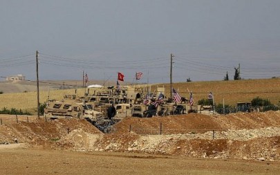 Vehicles of the US-backed coalition forces in the northern Syrian town of Manbij, May 8, 2018. (Delil souleiman/AFP)