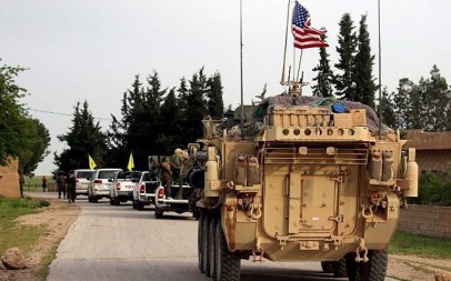 In this photo from April 28, 2017, US forces, accompanied by Kurdish People's Protection Units (YPG) fighters, drive their armored vehicles near the northern Syrian village of Darbasiyah, on the border with Turkey. (Delil Souleiman/AFP)