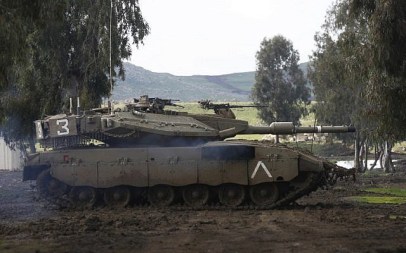 An Israeli army Merkava tank takes part in a military drill in the Israeli-annexed Golan Heights on February 12, 2019. (Photo by JALAA MAREY / AFP)