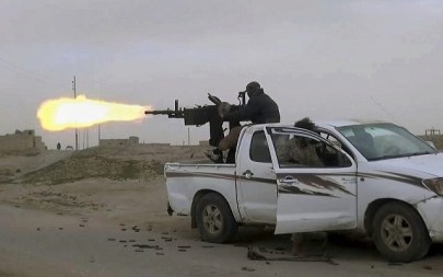 This frame grab from video posted online January 18, 2019, by supporters of the Islamic State group, purports to show a gun-mounted Islamic State group vehicle firing at members of the US-backed Syrian Democratic Forces, in the eastern Syrian province of Deir el-Zour, Syria. (Militant Photo via AP)