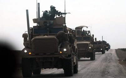 Military vehicles with the US-backed coalition against the Islamic State (IS) group during an operation to expel the jihadists, in the countryside of the eastern Syrian province of Deir Ezzor, February 21, 2019. (Delil Souleiman/AFP)