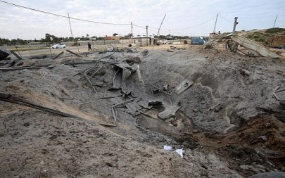 A Palestinian man walks past a crater on the ground following an Israeli air strike targeting a site belonging to Gaza's terror group Hamas, in Khan Yunis in the southern Gaza Strip, March 15, 2019. Israel struck Gaza terror targets after 2 rockets were fired at Tel Aviv from Gaza. (Said Khatib/AFP)