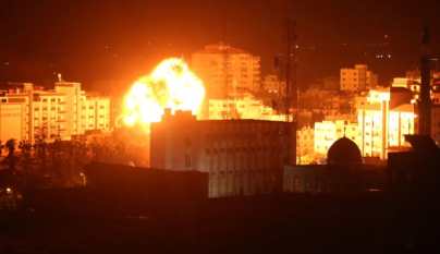 A ball of fire billows above buildings in Gaza City during reported Israeli strikes on March 25, 2019