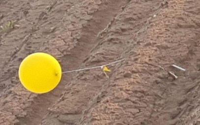 A balloon carrying a suspected explosive device from the Gaza Strip touches down in southern Israel on February 20, 2019. (Eshkol Security)