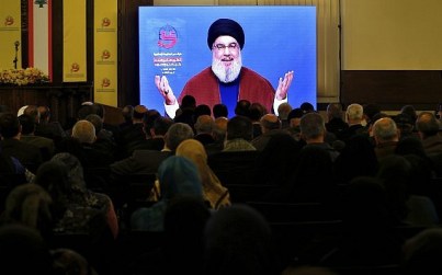 Supporters of the Iranian-backed Hezbollah terror group listen to a speech of Hezbollah leader Sayyed Hassan Nasrallah, via a video link, in a southern suburb of Beirut, Lebanon, March 8, 2019. (AP Photo/Bilal Hussein)