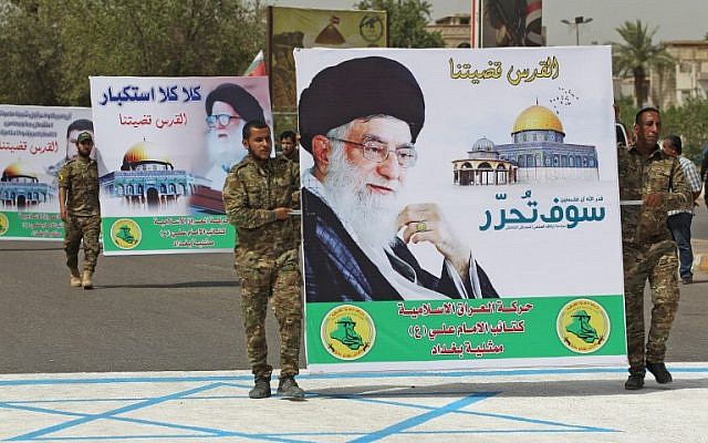 Shiite militiamen carry a poster of Iran's supreme leader, Ayatollah Ali Khamenei, while stepping on a drawing of an Israeli flag during a Jerusalem Day rally in the Iraqi capital Baghdad, June 8, 2018. (AFP/Ahmad Al-Rubaye) Shiite militiamen carry a poster of Iran's supreme leader, Ayatollah Ali Khamenei, while stepping on a drawing of an Israeli flag during a Jerusalem Day rally in the Iraqi capital Baghdad, June 8, 2018. (AFP/Ahmad Al-Rubaye)