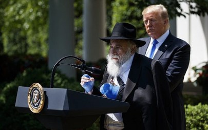 President Donald Trump looks on as Rabbi Yisroel Goldstein, survivor of the Poway, Calif synagogue shooting, speaks during a National Day of Prayer event in the Rose Garden of the White House, May 2, 2019. (AP/Evan Vucci)
