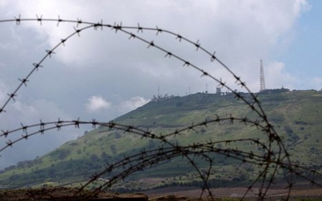 An Israeli military outpost in the Golan Heights is pictured from the Syrian town of Quneitra on March 26, 2019. (Louai Beshara/AFP)