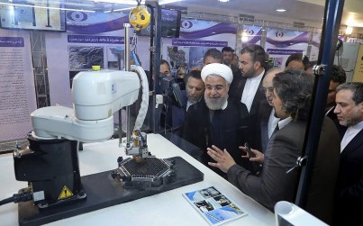 In this April 9, 2018 file photo, released by an official website of the office of the Iranian Presidency, President Hassan Rouhani listens to explanations on new nuclear achievements at a ceremony to mark "National Nuclear Day," in Tehran, Iran. (Iranian Presidency Office via AP, File)