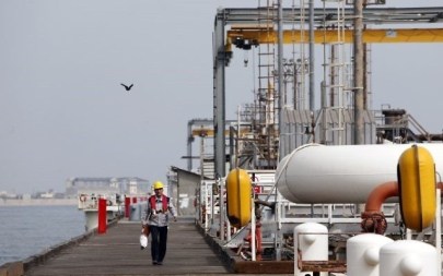 This photo from March 12, 2017, shows an Iranian laborer walking the platform of the oil facility in the Khark Island, on the shore of the Gulf. (AFP/Atta Kenar)