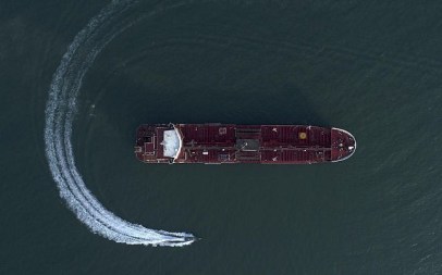 In this July 21, 2019 photo, an aerial view shows a speedboat of Iran's Revolutionary Guard moving around the British-flagged oil tanker Stena Impero which was seized in the Strait of Hormuz on Friday by the Guard, in the Iranian port of Bandar Abbas. (Morteza Akhoondi/Tasnim News Agency via AP)