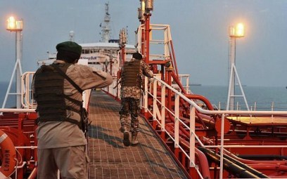 In this Sunday, July 21, 2019 photo, two armed members of Iran's Revolutionary Guard inspect the British-flagged oil tanker Stena Impero, which was seized in the Strait of Hormuz on Friday by the Guard, in the Iranian port of Bandar Abbas (Morteza Akhoondi/Mehr News Agency via AP)