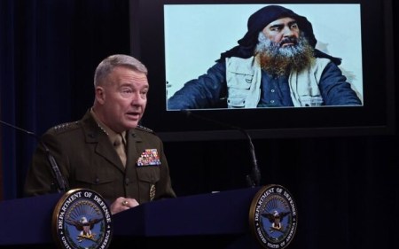 US Marine Corps Gen. Kenneth "Frank" McKenzie, commander of US Central Command, speaks as a picture of Abu Bakr al-Baghdadi is seen during a press briefing October 30, 2019 at the Pentagon in Arlington, Virginia. (Alex Wong/Getty Images/AFP)