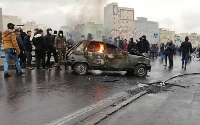 Iranian protesters gather around a burning car during a demonstration against an increase of gasoline prices, in the capital Tehran, November 16, 2019. (AFP)