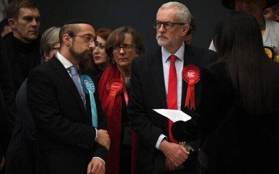 British opposition Labour Party leader Jeremy Corbyn, right, waits for the declaration of his seat in the 2019 general election in Islington, London, Dec. 13, 2019 (AP Photo/Alberto Pezzali)