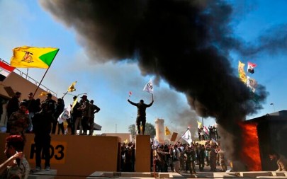 Protesters burn property in front of the US embassy compound, in Baghdad, Iraq, Dec. 31, 2019. (Khalid Mohammed/AP)