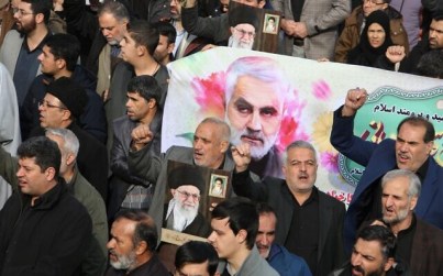 Iranians march with a banner bearing an illustration of Quds Force General Qassem Soleimani during a demonstration in Tehran on January 3, 2020, against the killing of the top commander in a US strike in Baghdad. (Atta Kenare/AFP)