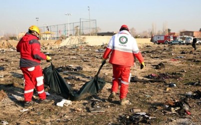 Rescue teams recover a body after a Ukrainian plane carrying 176 passengers crashed near Imam Khomeini airport in the Iranian capital Tehran on January 8, 2020, killing everyone on board. (AFP)