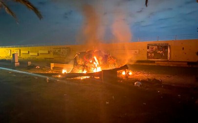 This photo released by the Iraqi Prime Minister Press Office shows a burning vehicle at the Baghdad International Airport following an airstrike in Baghdad, Iraq, early Friday, Jan. 3, 2020. (Iraqi Prime Minister Press Office via AP)