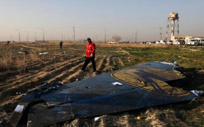 In this Wednesday, Jan. 8, 2020 photo a rescue worker searches the scene where a Ukrainian plane crashed in Shahedshahr southwest of the capital Tehran, Iran. (AP/Ebrahim Noroozi)
