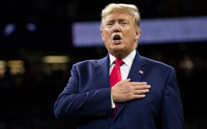 US President Donald Trump stands for the national anthem before the beginning of the NCAA College Football Playoff National Championship game between LSU and Clemson, in New Orleans, January 13, 2020. (Evan Vucci/AP)